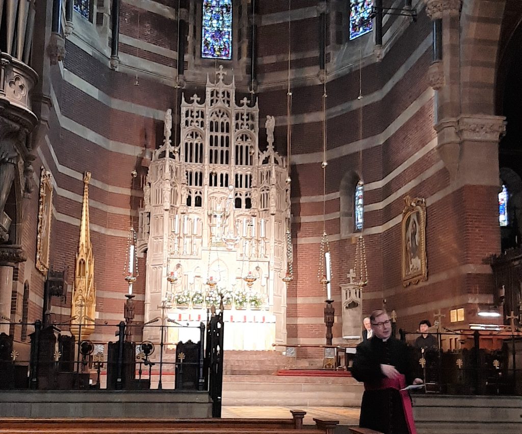 A priest introduces an organ recital